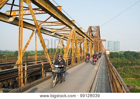People ride motorbike in Long Bien bridge in Hanoi, Vietnam