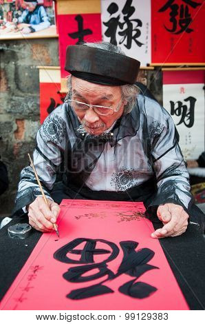 Old master is writing ancient letter for everyone in lunar new year in Hanoi, Vietnam