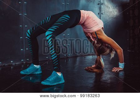 Bridge pose sporty woman doing fitness workout yoga stretching gymnastics exercise.