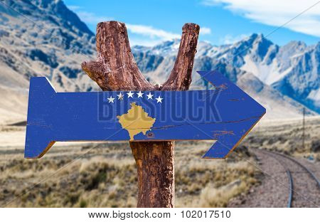 Kosovo Flag wooden sign with Railways Track background