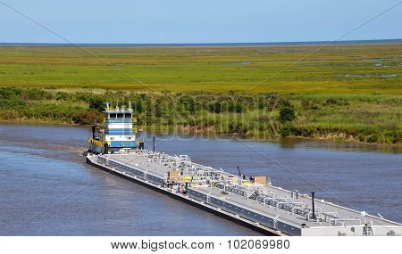 Oil barge being pushed by tugboat