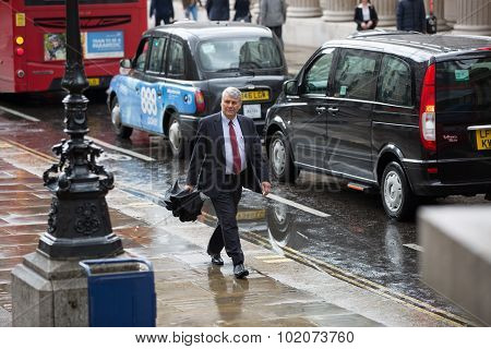 LONDON, UK - SEPTEMBER 17, 2015: Businessmen and businesswoman walking on the street against of Bank