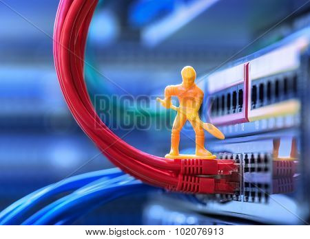 Miniature Technicians connecting network cable