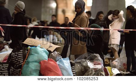 Syrian Refugees Listening to Announcement at Charity Collecting Point in Copenhagen Railroad Station