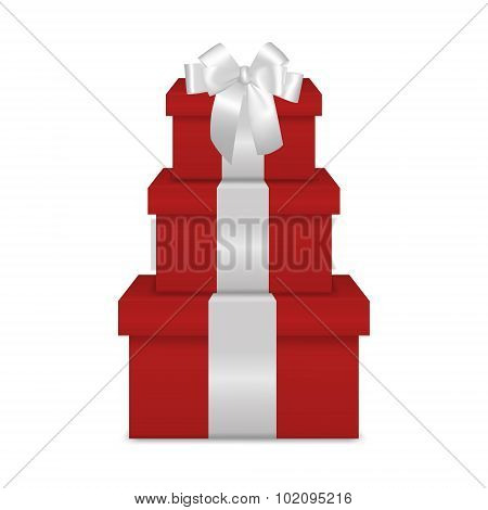 Stack of three realistic red gift boxes with white ribbon and bow