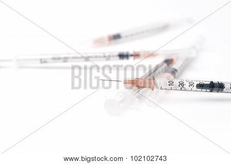 Five Disposable Syringes On The White Background