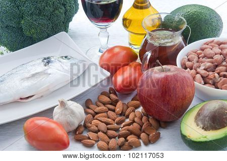 10 Foods To Lower Cholesterol : Tea , Avocado , Fruit , Vegetables,walnuts , Almonds , Fish , Wine