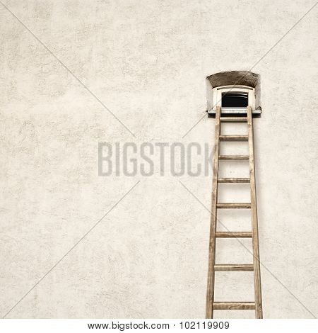 wall with a small window and wooden ladder