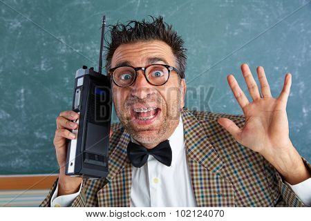 Nerd silly private investigator with retro walkie talkie on teacher bLAckboard