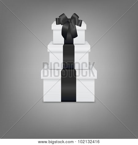 Stack of three realistic white gift boxes with black ribbon and bow