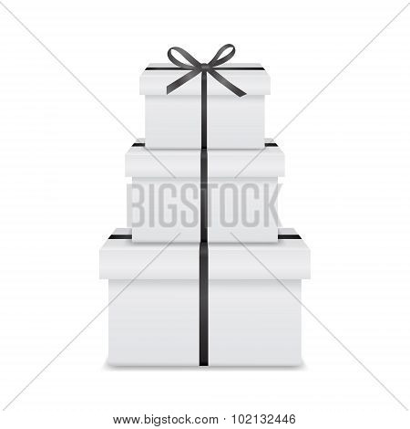 Stack of three realistic white gift boxes with black ribbon and bow