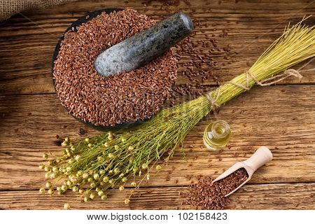 Top View On Board With Flax Seeds Plants And Oil