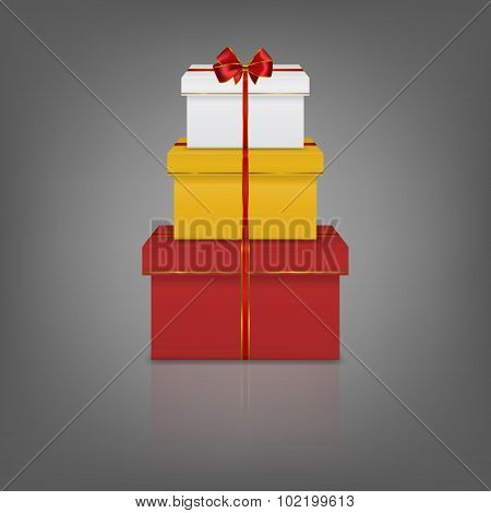 Stack of three realistic gift boxes with red ribbon and bow