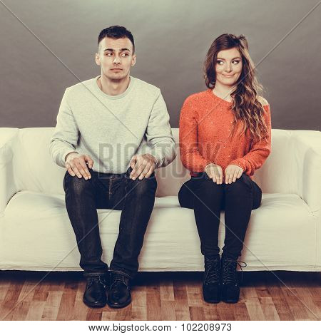 Shy Woman And Man Sitting On Sofa. First Date.