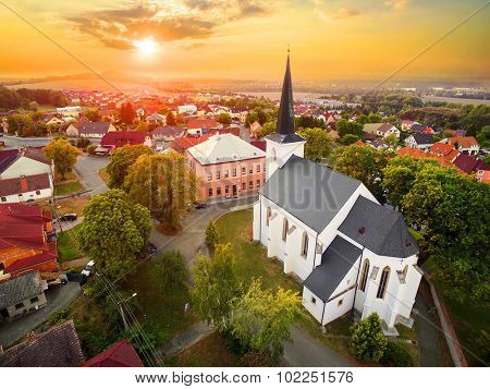 Beautiful sunset over gothic church St. Peter and Paul in The Litice suburb of Pilsen. Aerial view to romantic citiscape in Czech Republic, Central Europe. HDR (warm filtered) photography. 