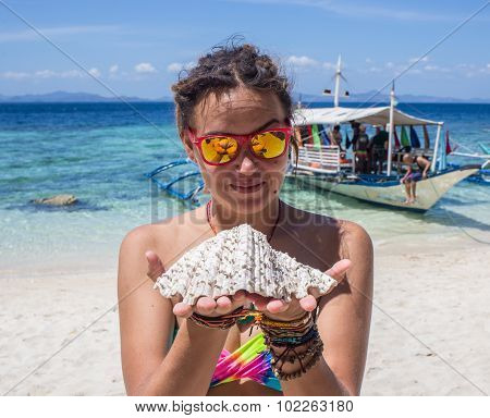 Young woman reaxing on the beach at exotic resort
