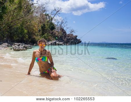 Young woman reaxing on the beach at exotic resort