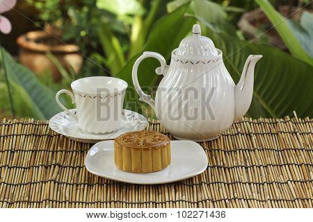 Moon Cake With Golden Lotus Seed And Macadamia Nut And Cup Of Tea