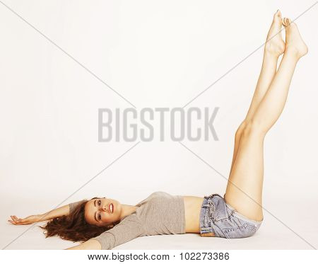 young pretty brunette woman head over heels on white isolated