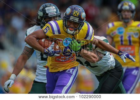 VIENNA, AUSTRIA - JUNE 22, 2014: WR Laurinho Walch (#6 Vikings) is tackled by CB Christian Kober (#31 Dragons).
