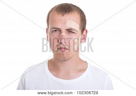 Sad And Injured Man With Adhesive Plaster On His Face