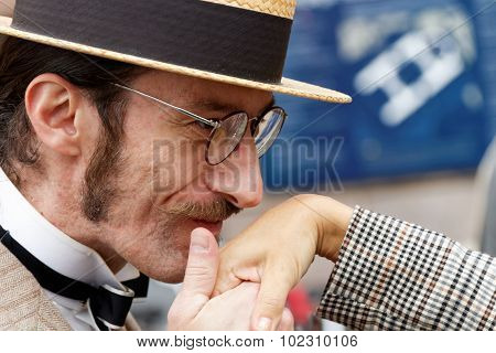 Man In Straw Hat Kissing Elegant Lady's Hand