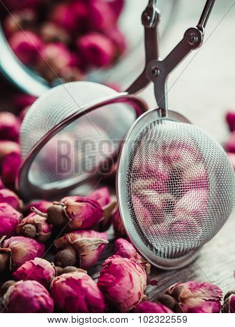 Rose Buds Tea, Tea Strainer And Glass Jar Closeup. Selective Focus.