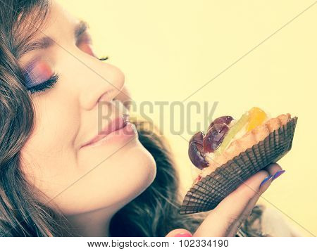 Woman Closed Eyes Holds Cake In Hand