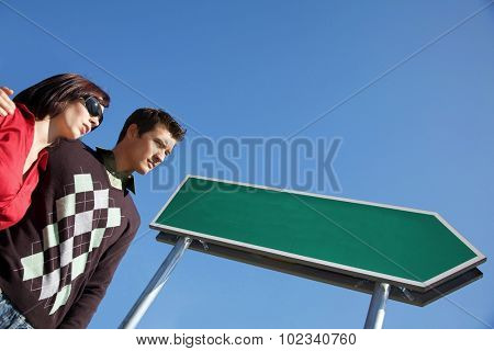 Low angle view of young couple with arm around