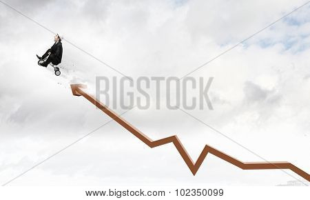 Young funny businessman riding three wheeled bicycle