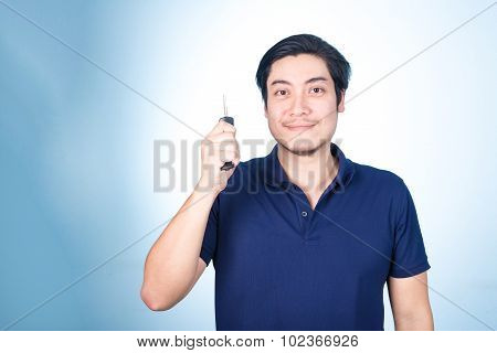 Asian Handsome Man With The Keys Of His New Car, On Blue Background