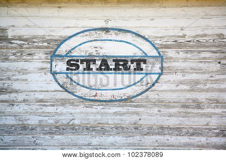 Start sign on weathered shed side