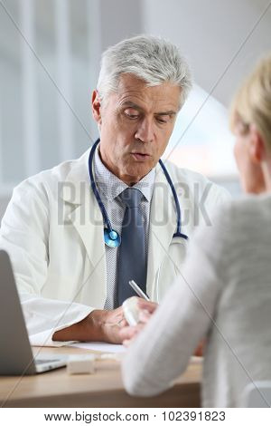 Doctor having consultation with patient in office