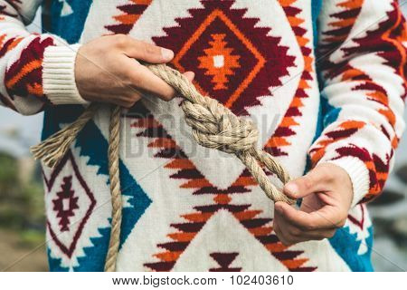Man hands holding rope knot Travel Lifestyle survival concept