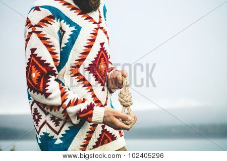 Man hands holding rope knot Travel Lifestyle survival concept