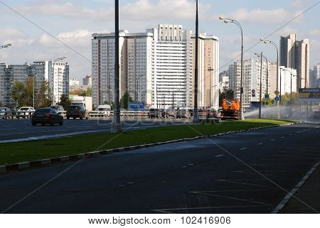 Moscow, Russia, September 19 2015, Leninist avenue. The Special machine waters the lawn..