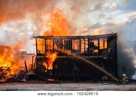 Fireman Extinguishes A Burning House