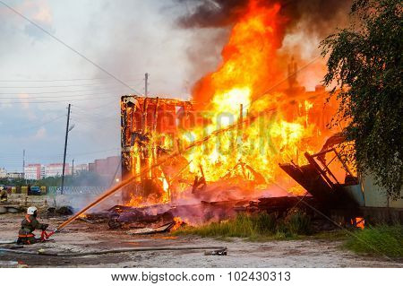 Fireman Extinguishes A Burning House
