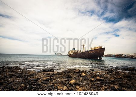 old broken ship agrounded near Lanzarote seashore, Canary Islands, Spain