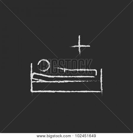 Patient lying in bed hand drawn in chalk on a blackboard vector white icon isolated on a black background.