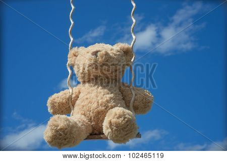Teddybear on a swing