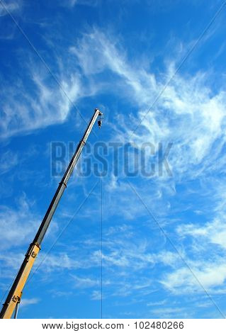 Boom Of The Crane On A Diagonal Against A Blue Sky