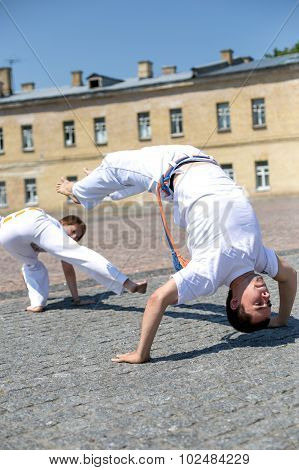 Two strong capoeira experts fighting
