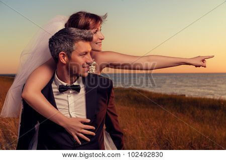 wedding couple outstretched finger showing destination