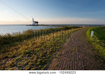 Idyllic lighthouse from the dike at sunrise