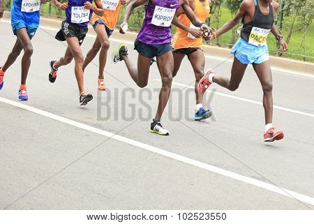 Marathon runners running on city road