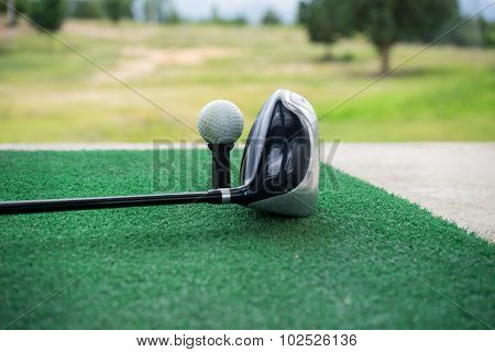 Close-up Of A Golf Ball And A Golf Wood On A Driving Range