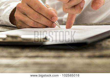 Closeup Of Male Hand Pointing Where To Sign A Contract