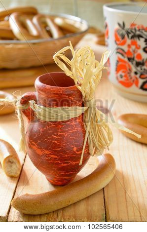 decorative tiny red jug on wooden table