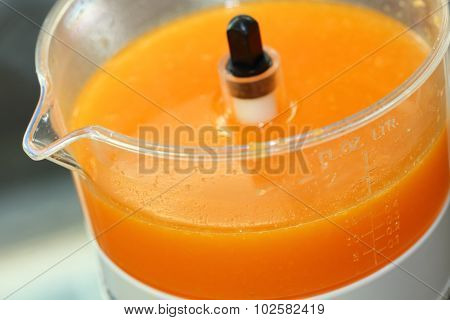 Fresh Orange Juice In Juicer Machine With Hand